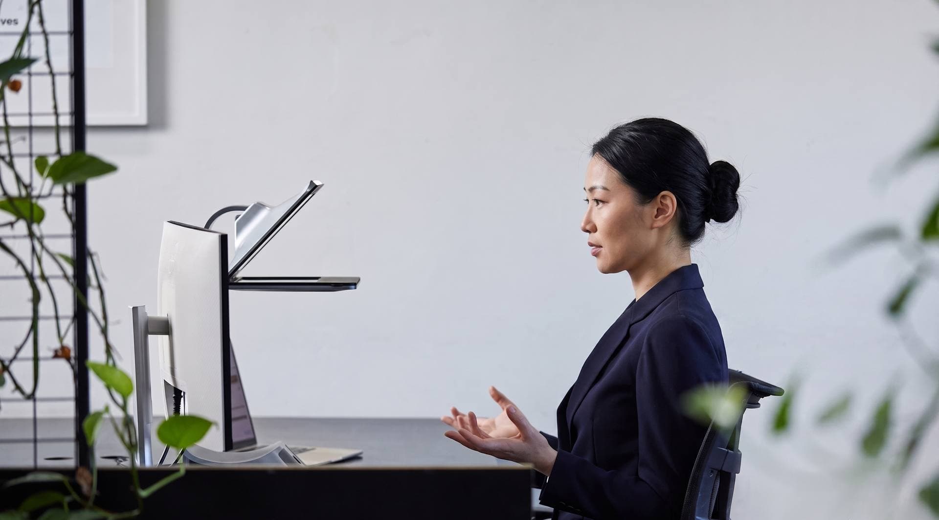 Side profile of a woman on a video call, speaking to the iVi at eye level